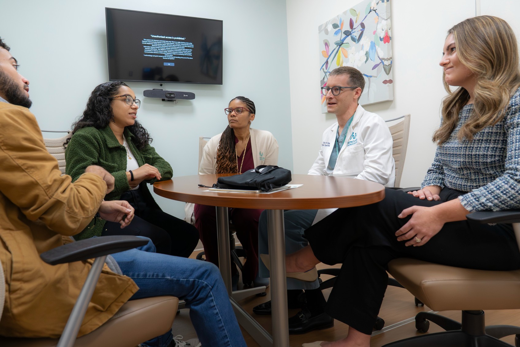 Team of genetic counselors having a collaborative and supportive conversation about parental genetic screening results.